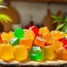 Indulge in Weed Gummies with colorful varieties displayed elegantly on a natural wooden platter.